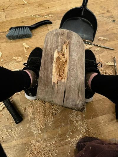 Pic 2 - Vicki Lowe at work carving the tree stump found in the sea near her home.jpg