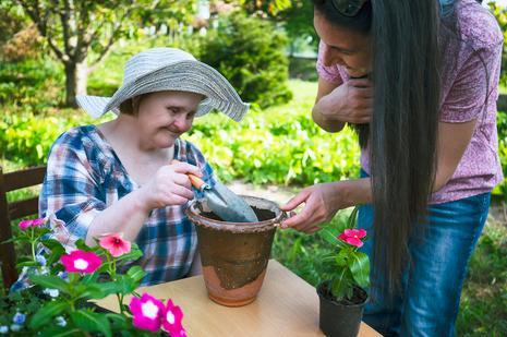 Image of care worker and lady in garden